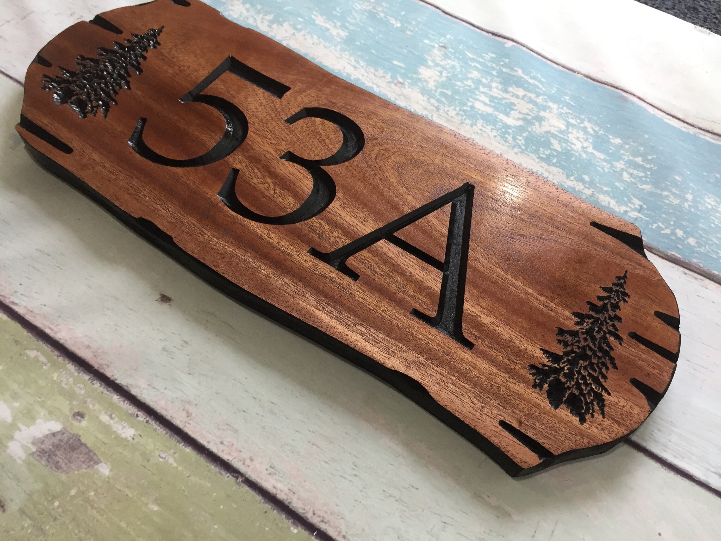 Wooden address sign with large carved numbers