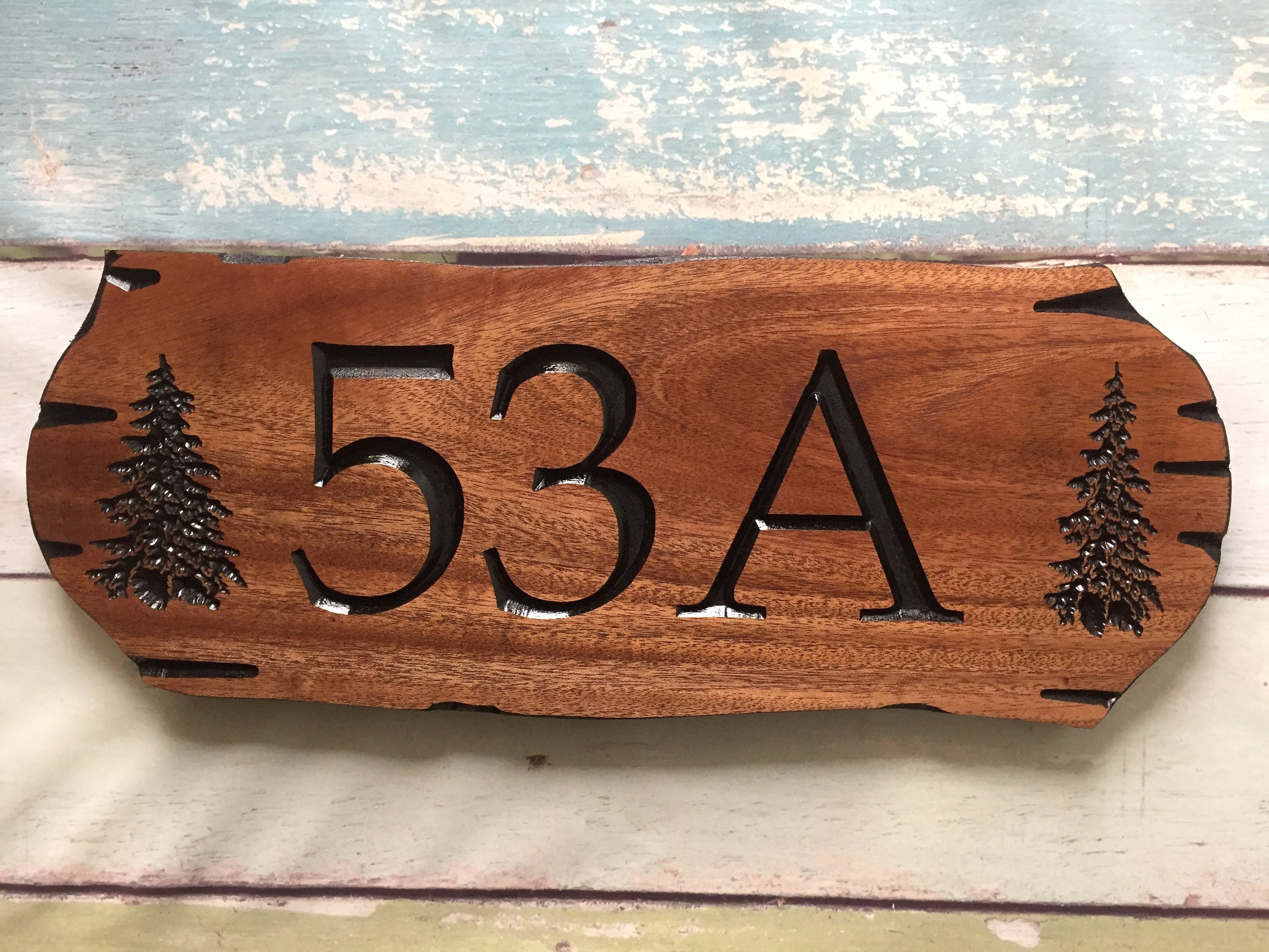 Wooden address sign with large carved numbers