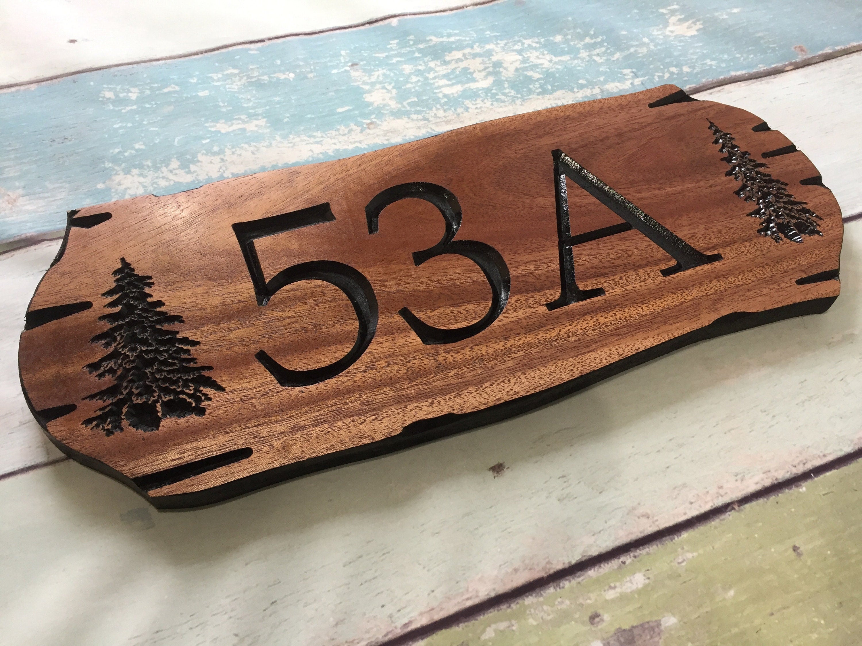 Wooden address sign with large carved numbers