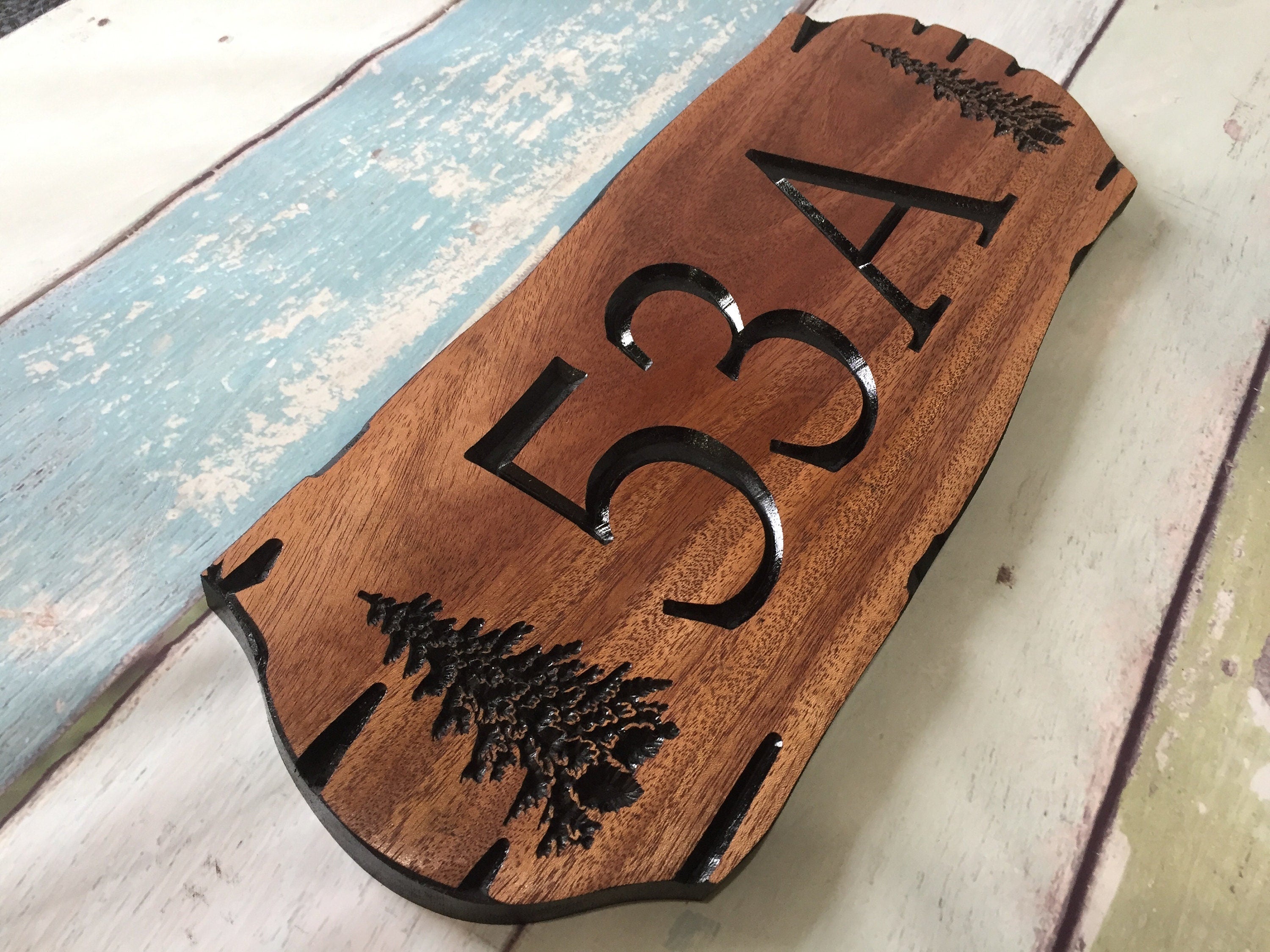 Wooden address sign with large carved numbers