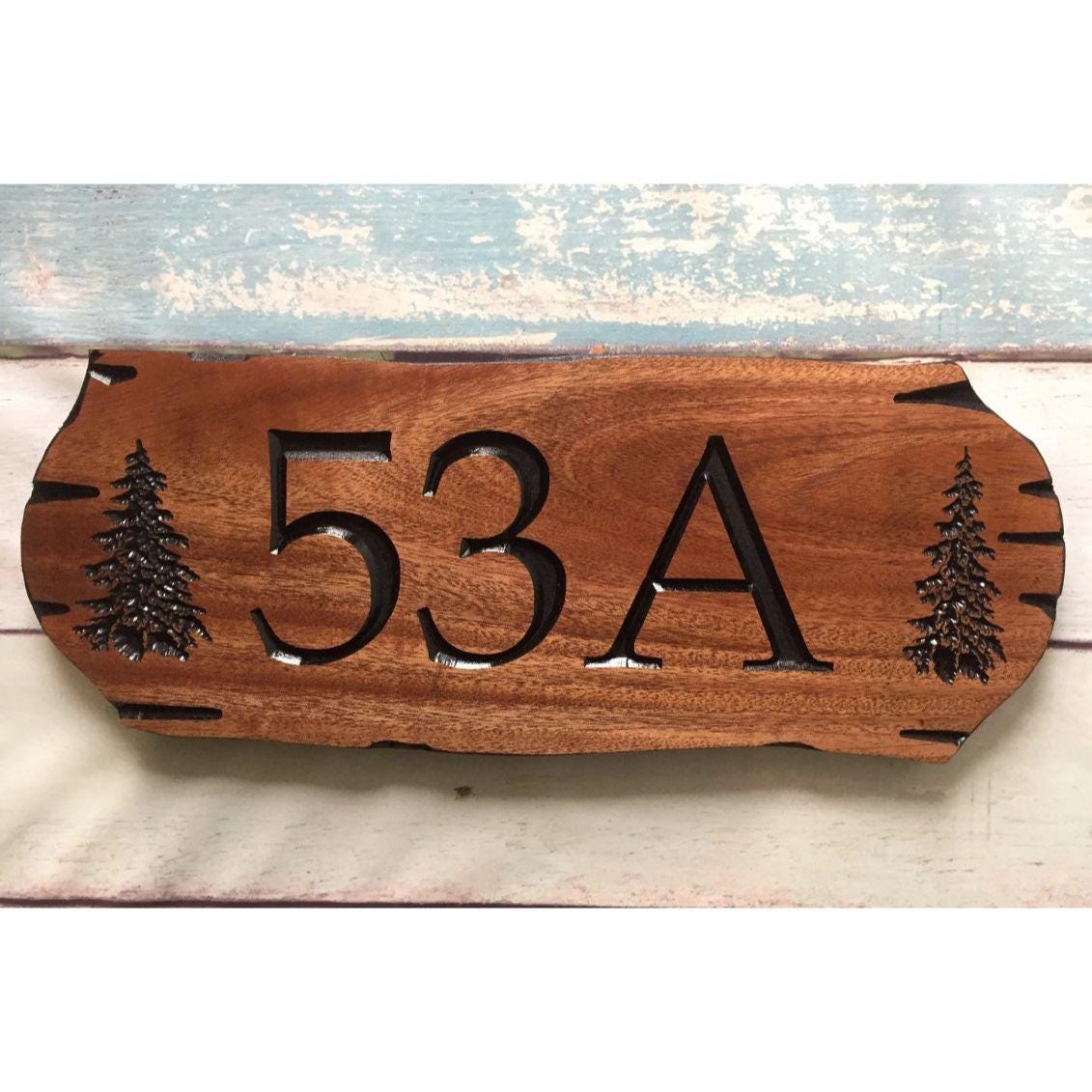 Wooden address sign with large carved numbers